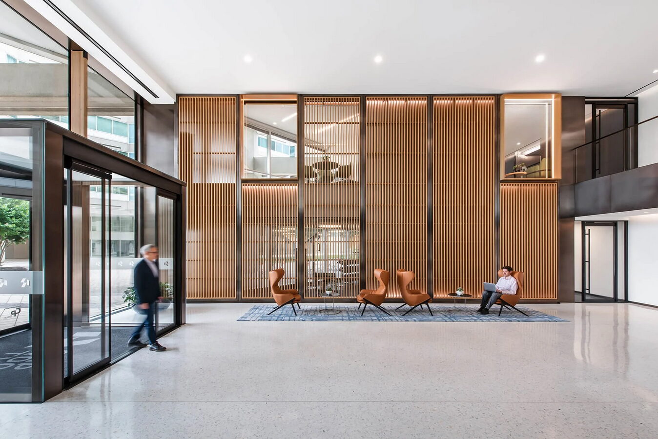Wood-paneled building lobby with lounge seating at the CapRock office campus in Bethesda