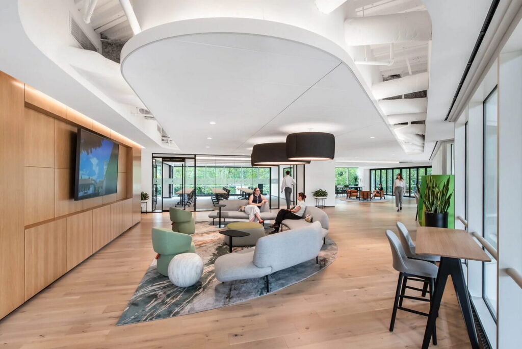 Tenant lounge with sofas and café tables available to coworking members at the CapRock campus in Bethesda