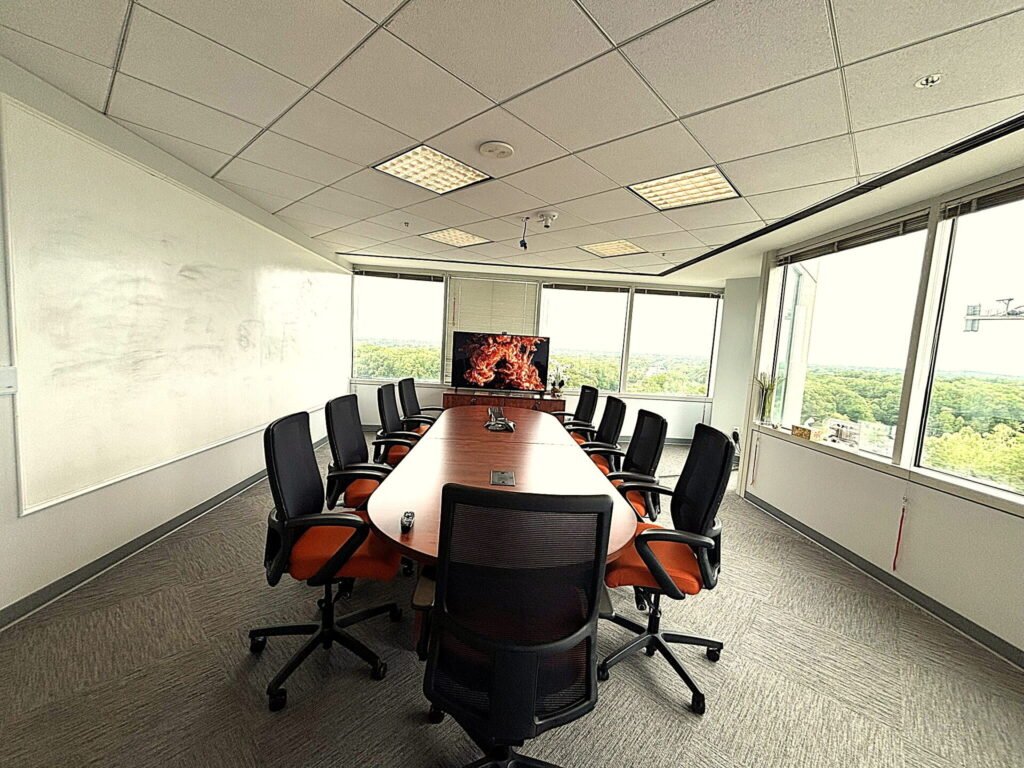 Meeting room with full whiteboard wall and conference table for small and mid-size groups in Bethesda, MD