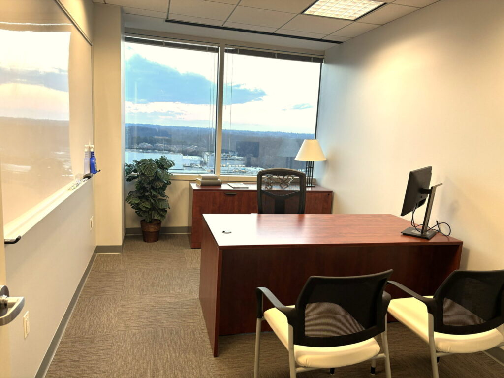 Bright private office with executive desk, guest seating and whiteboard at Pioneer Office Suites, Bethesda