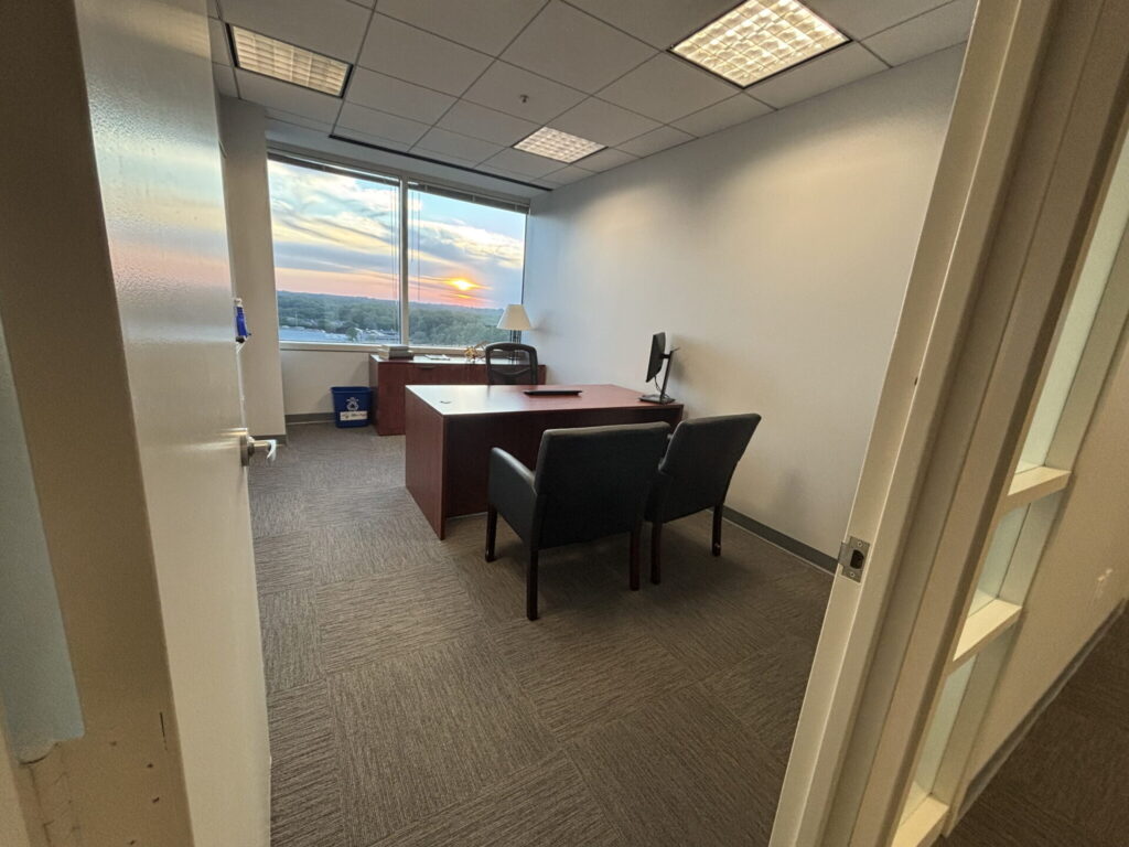 Team room with two desks and window views for small teams at Pioneer Office Suites in Bethesda, MD